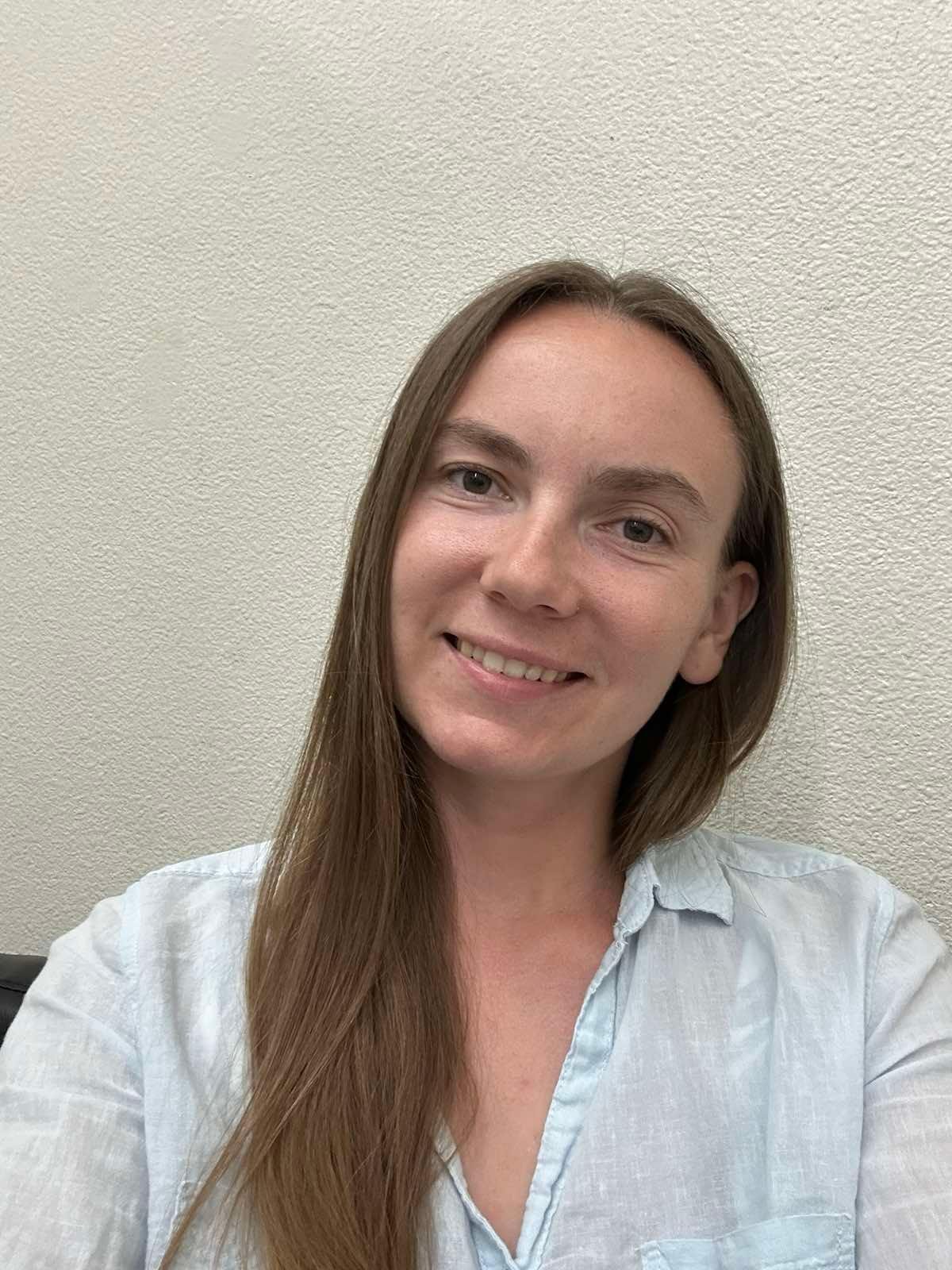 Young female teacher assistant smiling